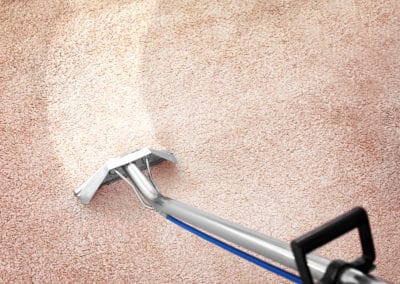 Removing dirt from carpet with professional vacuum cleaner indoors